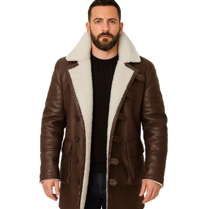 A men’s brown Bane-inspired leather coat featuring a distressed finish, a thick cream-colored shearling collar, and a rugged, long-length design.
