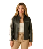 A woman modeling an oversized black leather racer jacket featuring cream-colored vertical stripes on the sleeves and a sleek stand collar.